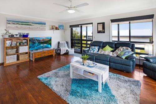 a living room with a couch and a table at Livin the Dream in Lakes Entrance