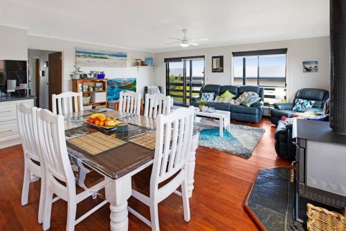 a kitchen and living room with a table and chairs at Livin the Dream in Lakes Entrance