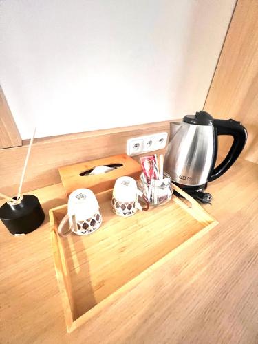 a tray with a coffee pot and cups on a counter at Hotel Karlin in Prague
