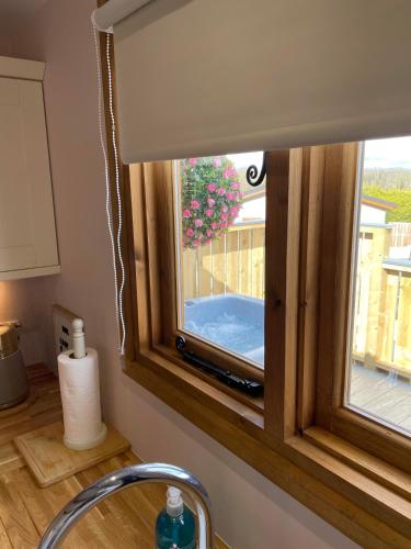 a window in a kitchen with a window shade at Hafod Shepherd Hut in Aberystwyth