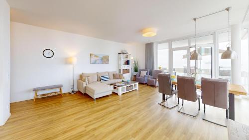 a living room with a couch and a table at Südkap H-02 in Pelzerhaken