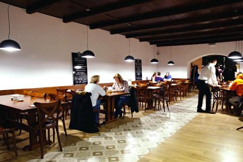 a group of people sitting at tables in a restaurant at Kyjovský pivovar - hotel, restaurace, pivní lázně in Kyjov