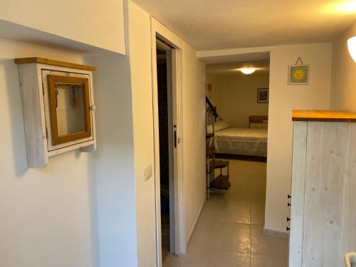 um corredor que leva a uma sala com um quarto em Casa zia Vincenzina em Casalvecchio Siculo