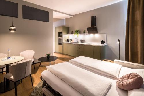 a hospital room with a bed and a table at KOOS Hotel&Apartments - City Aparthotel in Munich