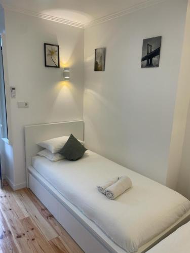 ein Bett mit zwei Handtüchern auf einem Zimmer in der Unterkunft Apartamento Pensamento Inédito 55 in Lissabon