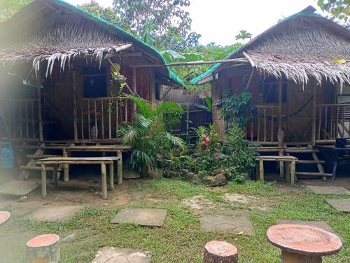 a hut with benches and tables in front of it at YOUMEBED MOTOR INN at Kambal Kubo Resthouse in Antipolo