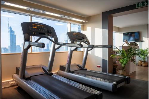 two treadmill machines in a gym with a window at Novotel Warszawa Centrum in Warsaw