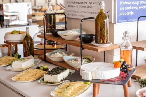 a buffet filled with different types of food and bottles of wine at Novotel Warszawa Centrum in Warsaw