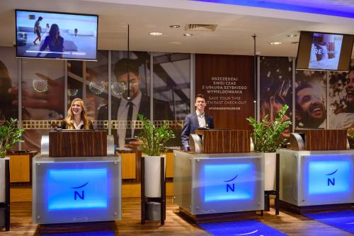 a man and woman standing at a podium in a room at Novotel Warszawa Centrum in Warsaw