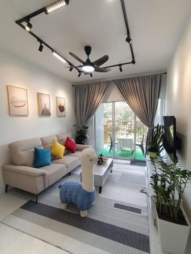 a living room with a couch and a table at Dream 5 @ Emerald avenue in Brinchang