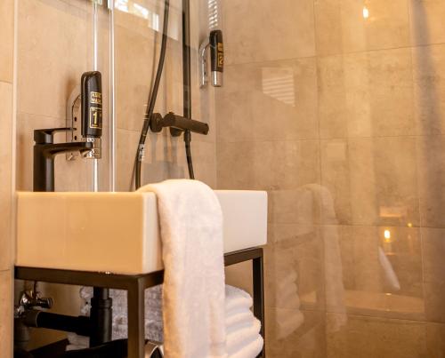 a bathroom with a sink and a shower at Hotel Bom in Burgh Haamstede