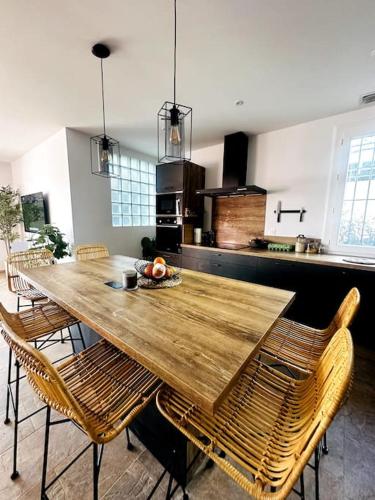 une grande table en bois avec des chaises dans la cuisine dans l'établissement Grande villa proche de la mer, à Canet