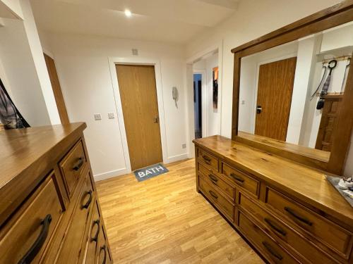 a bathroom with a large mirror and a wooden dresser at Juli’s cosy home in London