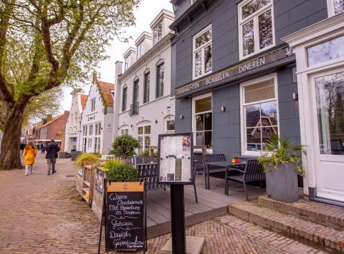 a street in a town with buildings and a sign at Hotel Bom in Burgh Haamstede