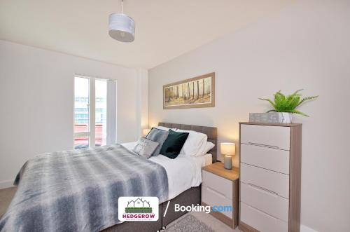 um quarto com uma cama e uma cómoda em Deluxe 2 Bed 2 Bath Manchester City Centre Apartment By Hedgerow Properties Limited em Manchester