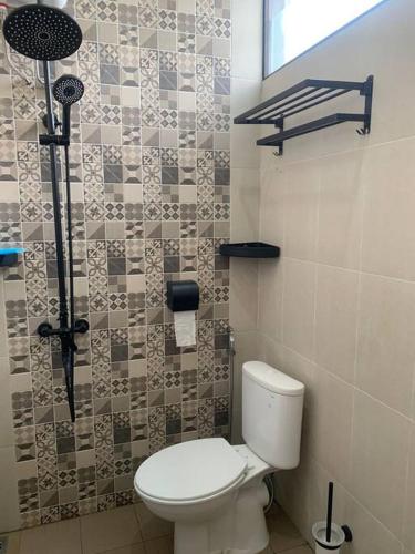 a bathroom with a toilet and a shower at AdyneVille in Malang