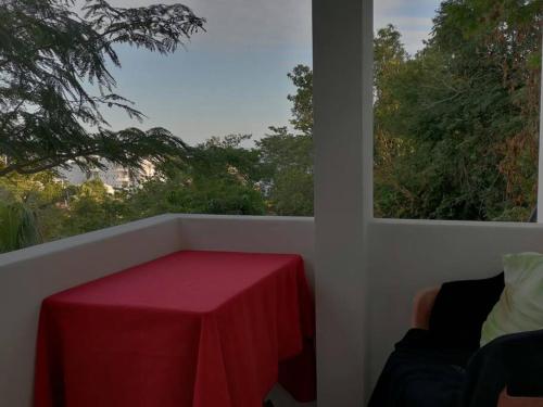 a table with a red table cloth on a balcony at Loft Vista Mar en Puerto Ángel in Puerto Ángel