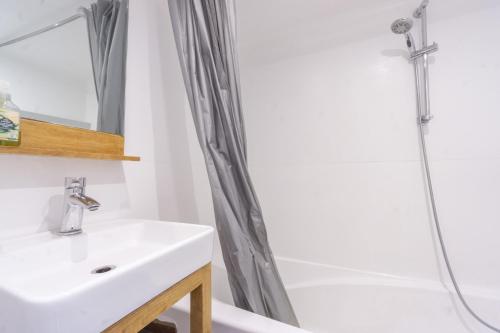 a bathroom with a sink and a shower at Arc 2000 appartement type chalet in Bourg-Saint-Maurice