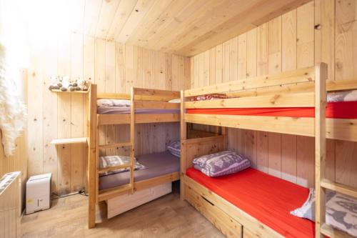 a wooden cabin with two bunk beds in it at Arc 2000 appartement type chalet in Bourg-Saint-Maurice