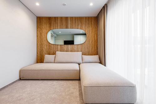a couch in a room with a mirror at Tavel Hotel & SPA in Bukovel