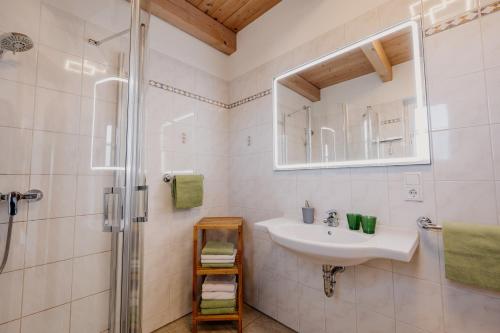 a white bathroom with a sink and a shower at Weingut Sternat vlg. Schmalzpeter in Arnfels