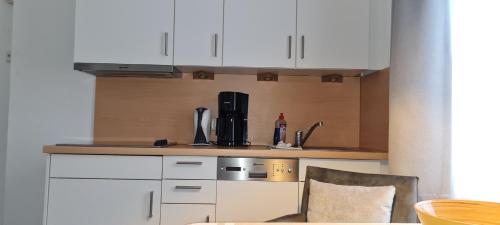 a kitchen with a coffee maker on a counter at Ferienhaus Pauls Ferienhaus Pauls, Whg 10 in Norderney