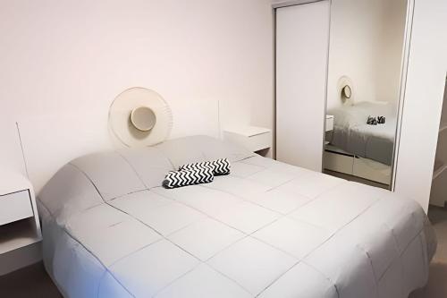 - une chambre blanche avec un lit blanc et un miroir dans l'établissement Bello departamento zona centro, à Rosario
