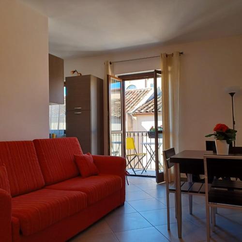 a living room with a red couch and a table at Genius Home in Palermo