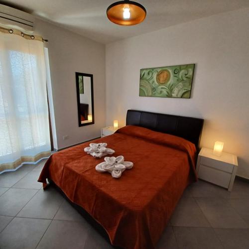 a bedroom with a bed with two towels on it at Genius Home in Palermo