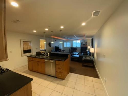 a kitchen and living room with a sink and a couch at Beautiful First Floor suite with patio to the Bay in Traverse City
