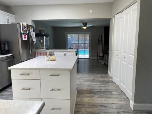 a kitchen with a white counter and a refrigerator at Backyard oasis family fun! in St Petersburg