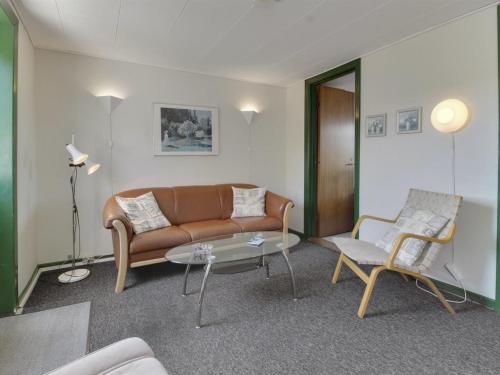 a living room with a couch and a table at Apartment Withar - all inclusive - 800m from the sea by Interhome in Fanø