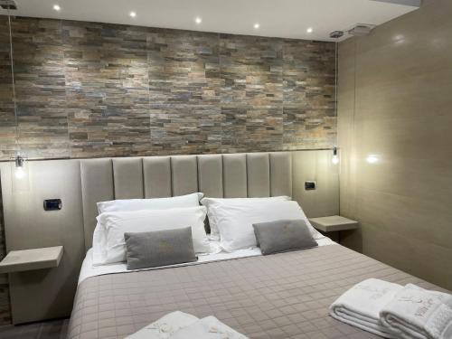 a bedroom with a large bed with two pillows at Villa Carly Taormina apartment with private pool in Trappitello