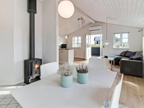 een woonkamer met een open haard en een bank bij Holiday Home Baarde - all inclusive - 60m from the sea by Interhome in Grenå