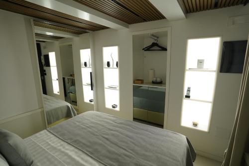 a bedroom with two beds and two windows at Barneys B&b in Cercola