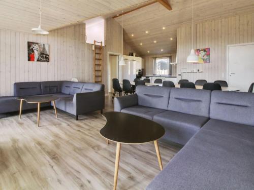 a living room with couches and a table and chairs at Holiday Home Eilen - all inclusive - 3-3km from the sea by Interhome in Rømø Kirkeby