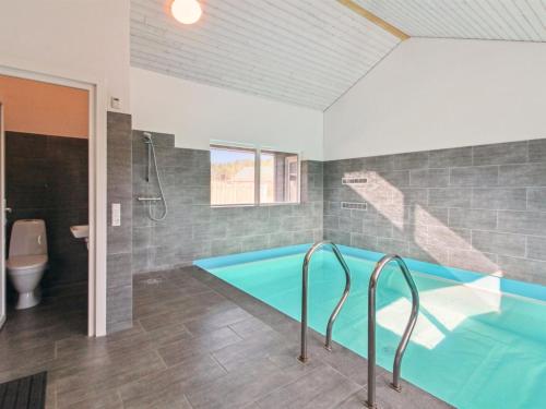 a swimming pool in a bathroom with a toilet at Holiday Home Blaga - all inclusive - 3-3km from the sea by Interhome in Rømø Kirkeby