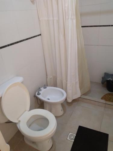 a bathroom with a toilet and a sink at Queto in Santa Fe