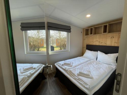 a small bedroom with two beds and a window at Holiday Home Tiny Haus Marion by Interhome in Riedenburg