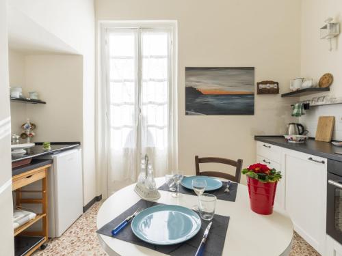 a kitchen with a table with two plates on it at Apartment Casa Adele by Interhome in Imperia
