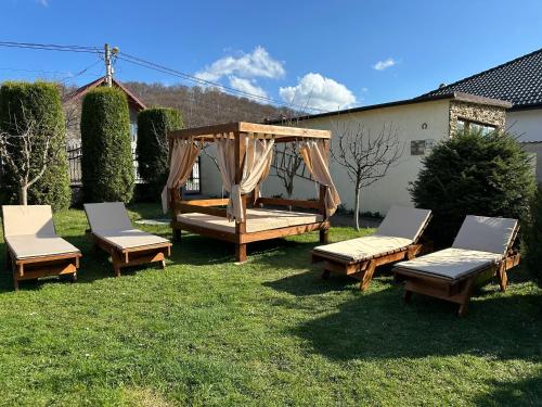 3 sedie e un gazebo in un cortile di Emerald Residence a Rîşnov