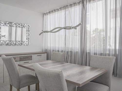 a dining room with a table and chairs and a mirror at Villa Villa Marina by Interhome in Playa Blanca