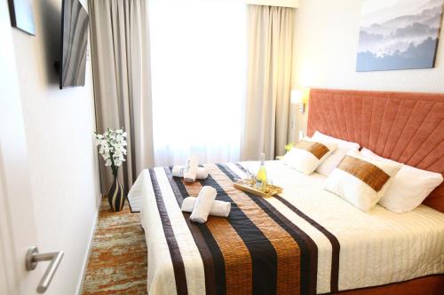 a hotel room with a bed with two teddy bears on it at Sunny Haven Bel Mare Parking, Basen FREE in Międzyzdroje