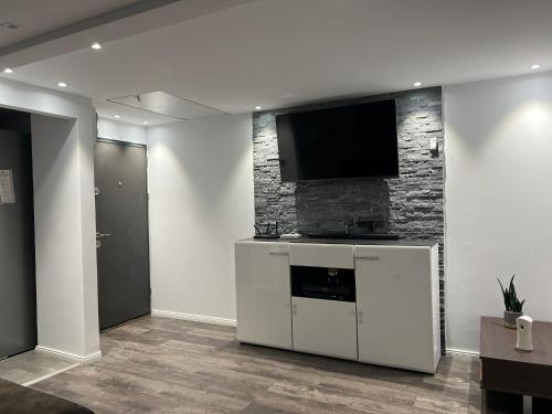 a living room with a flat screen tv on a wall at Apartament Mansarda Venus in Râmnicu Vâlcea