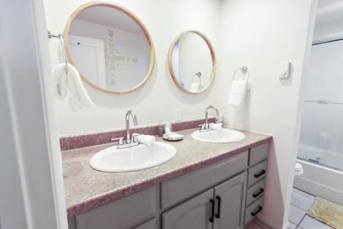 a bathroom with two sinks and two mirrors at Boho Modern Retreat with Mountain Views Unit 1 Durango in Durango