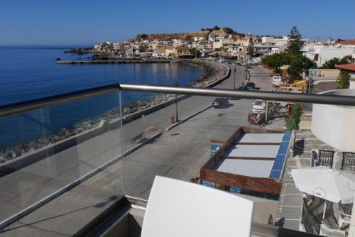 a balcony with a view of the ocean and a city at Ocean Dreams in Palaiochóra