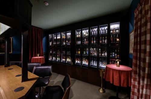 a bar with a lot of bottles of alcohol at Dunfallandy House Hotel in Pitlochry