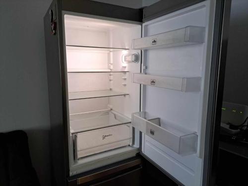 an empty refrigerator with its door open in a room at Zoev in Plovdiv