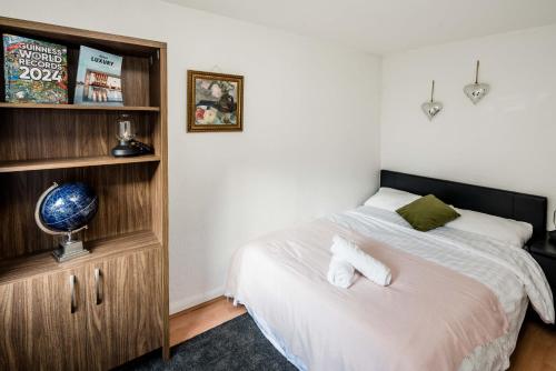 a bedroom with a bed and a book shelf at Affordable Flat in Fitzrovia in London