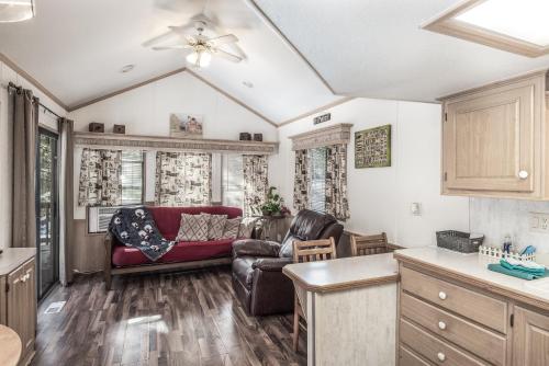 a living room with a couch and a table at Rainbow Lake Cabin & RV Resort in Ruidoso